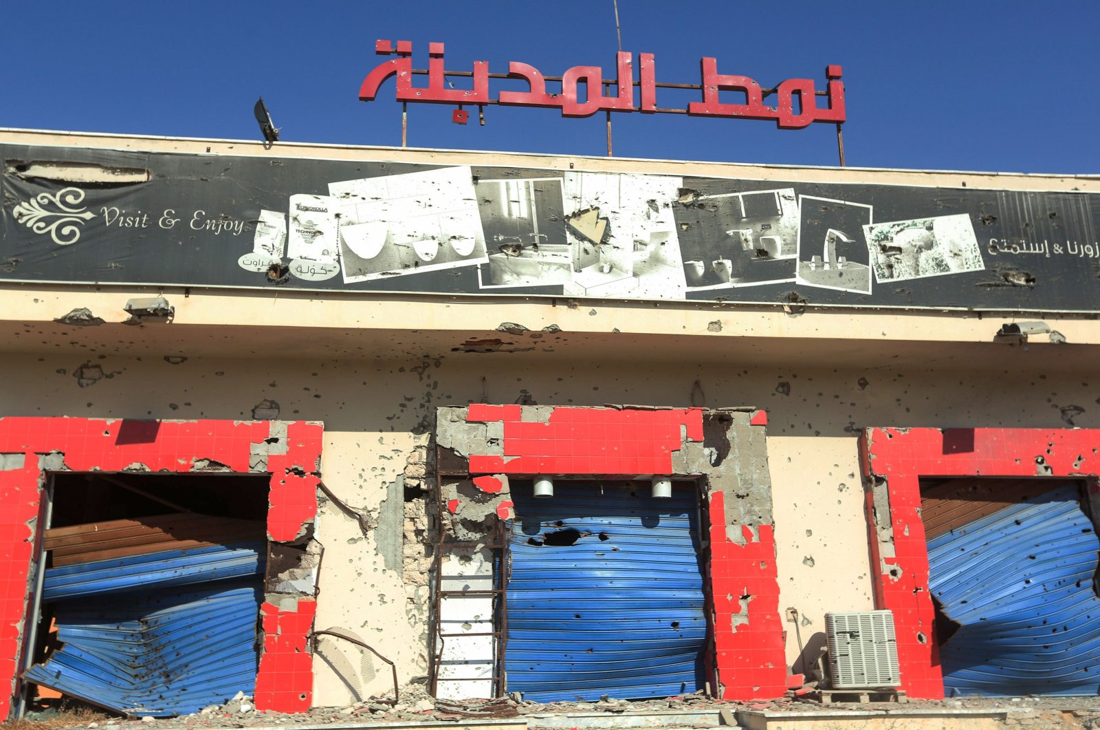 A shop, damaged during the 14 months of fighting between the U.N.-recognized Government of National Union (GNA) and putschist Gen. Khalifa Haftar, in a southern neighborhood in the capital Tripoli, July 9, 2020. (AFP Photo)