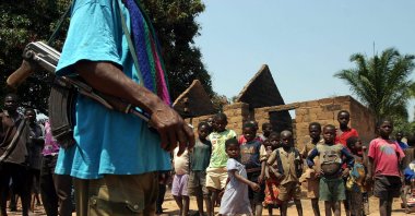 A government soldier stands guard in the remains of the burnt out village of Kabula, near Mukana village in Congo's Katanga region, August 21, 2005. (Reuters Photo)
