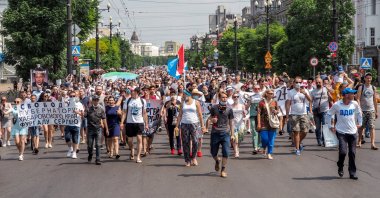 People hold posters that read: "Freedom for Khabarovsk region's governor Sergei Furgal" during an unsanctioned protest in support of Sergei Furgal, the governor of the Khabarovsk region, in Khabarovsk, 6100 kilometers (3800 miles) east of Moscow, Russia, Saturday, July 18, 2020. (AP Photo)