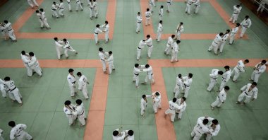 Judokas wrestle during a weekly freestyle practice session in Tokyo, Japan, Feb. 19, 2020. (AFP Photo)