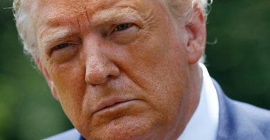 President Donald Trump listens to a reporter's question on the South Lawn of the White House in Washington, July 15, 2020. (AP Photo)