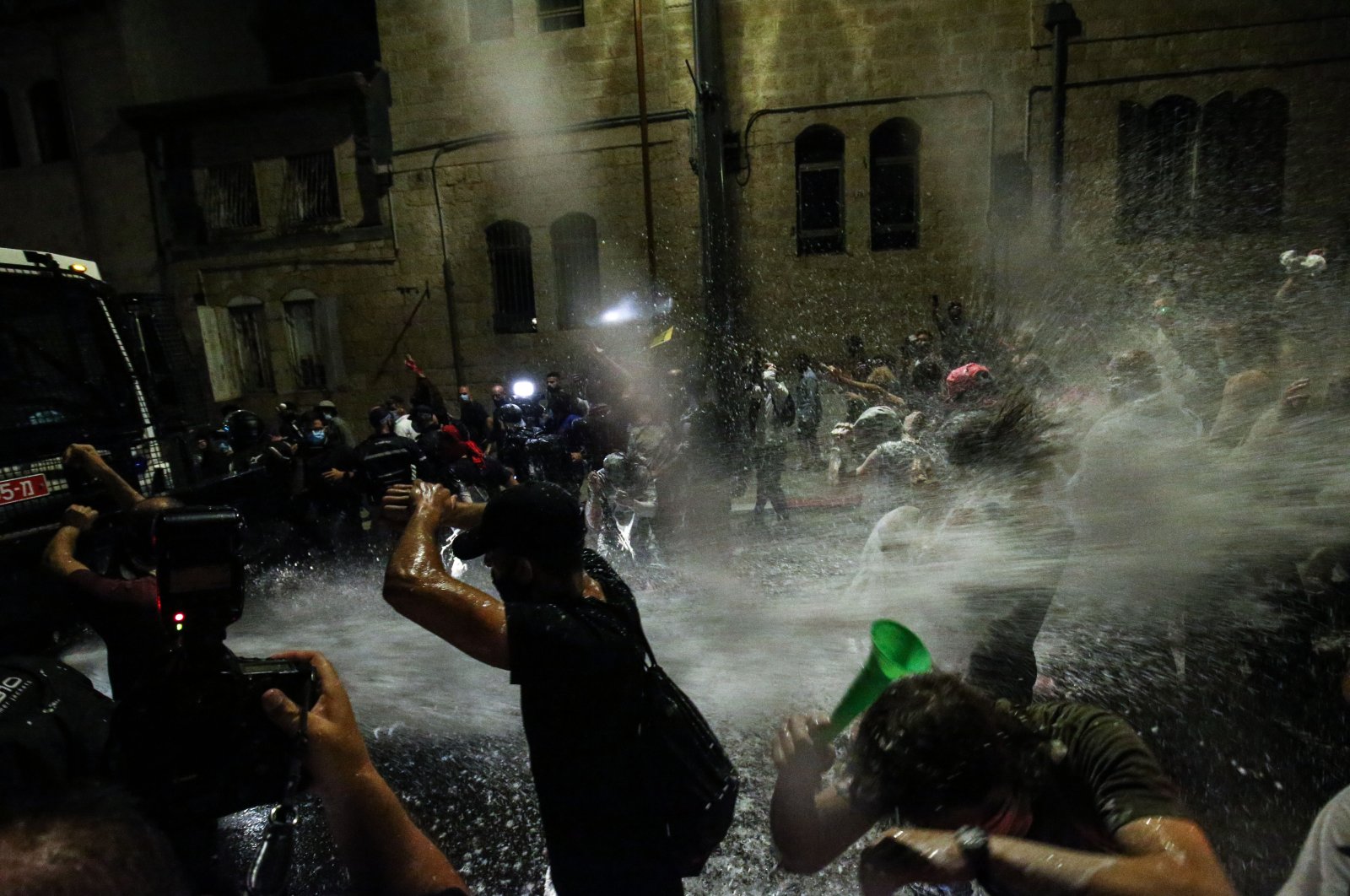 Israeli police use water cannons to disperse demonstrators protesting against the government response to the coronavirus pandemic in Jerusalem on July 18, 2020. (AA Photo)