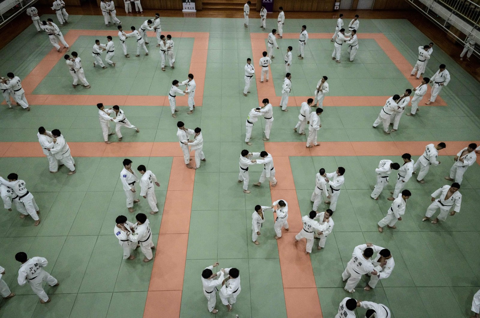 Judokas wrestle during a weekly freestyle practice session in Tokyo, Japan, Feb. 19, 2020. (AFP Photo)