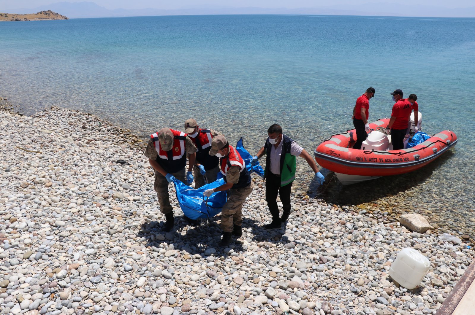 Turkish security forces carry the recovered bodies of the refugees in eastern Turkey's Lake Van, July 19, 2020. (AA)