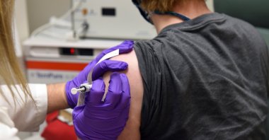 The first patient enrolled in Pfizer's COVID-19 coronavirus vaccine clinical trial at the University of Maryland School of Medicine receives an injection in Baltimore, Maryland, May 4, 2020. (AP Photo)