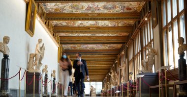People walk in the Uffizi Gallery during a press tour on the reopening day of the museum, in Florence, Italy, June 3, 2020. (AP Photo)