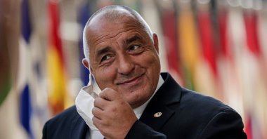 Bulgaria's Prime Minister Boyko Borissov takes off his protective face mask as he arrives for an EU summit at the European Council building in Brussels, July 18, 2020. (AP Photo)