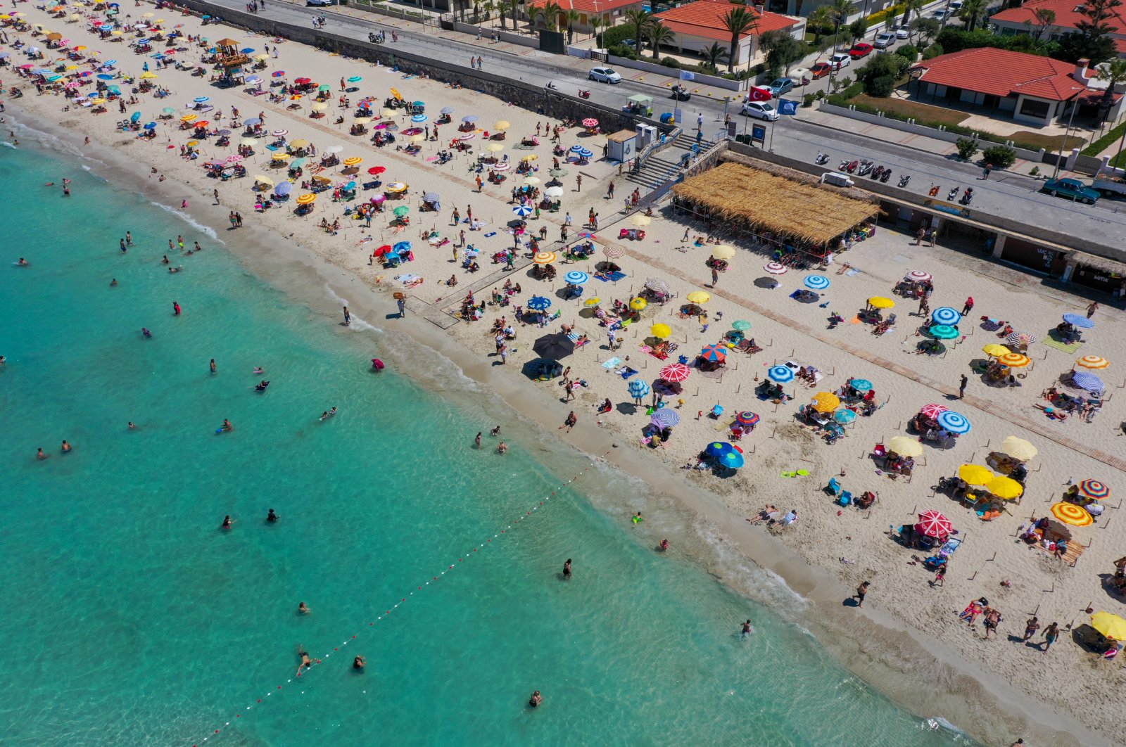 Tourists enjoy the sun at Ilıca Beach in Çeşme, a resort town west of Izmir, in Turkey's Aegean region, July 19, 2020. (AA Photo)