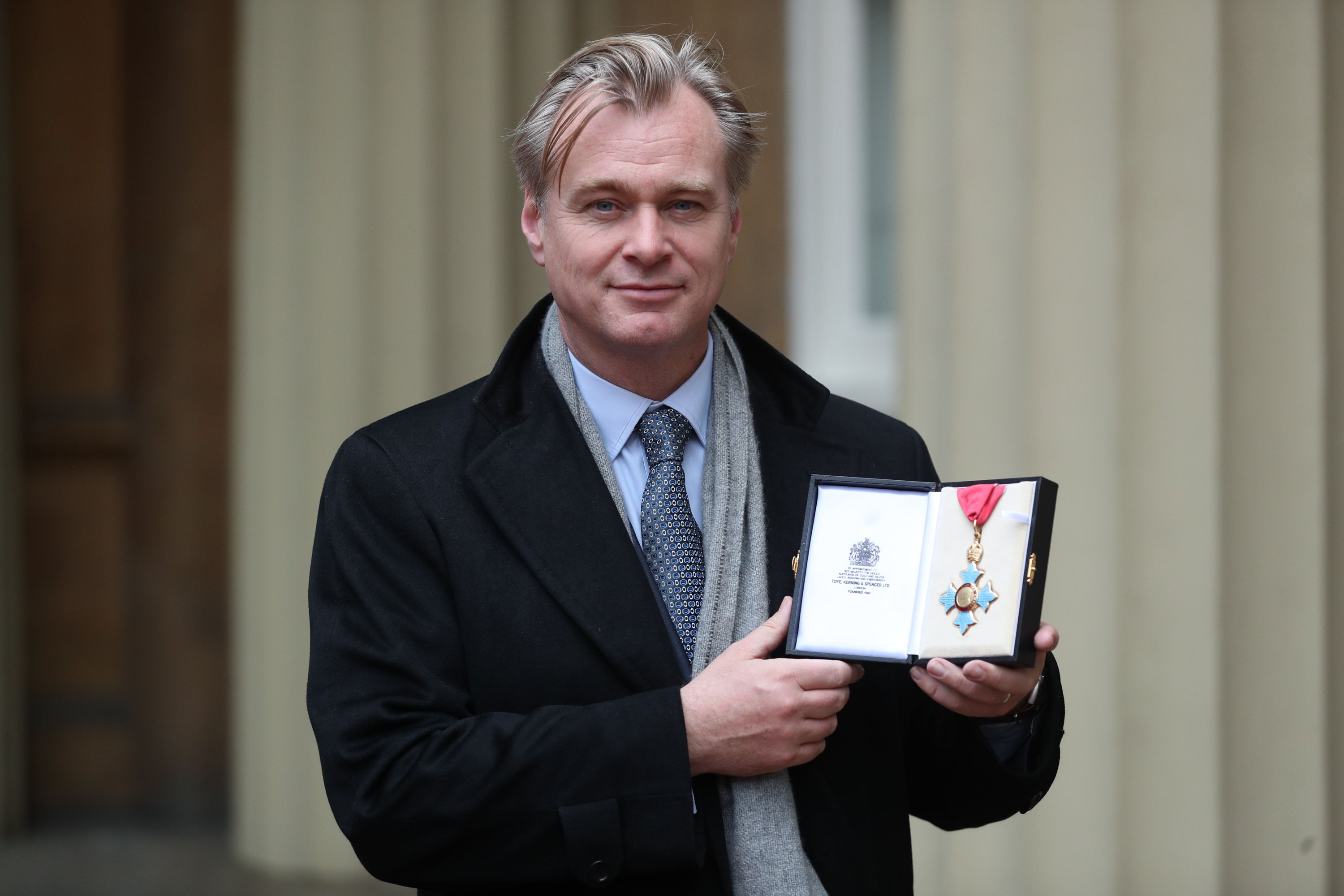 British-American director Christopher Nolan poses with his medal after he was made a Commander of the British Empire (CBE) for services to film during an investiture ceremony at Buckingham Palace, London, Dec. 19, 2019. (AFP Photo)