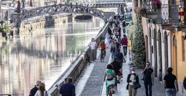 People walk along the popular Navigli area during the coronavirus outbreak, Milan, Italy, May 8, 2020. (AP Photo)