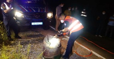 Gendarmerie officers open the barrel containing the body, in Muğla, southwestern Turkey, July 21, 2020. (DHA Photo) 
