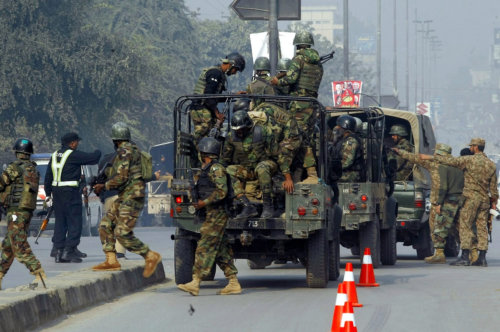 Pakistan Army troops arrive to conduct an operation at a school under attack by Taliban gunmen in Peshawar, Pakistan, Dec. 16, 2014. (AP Photo)