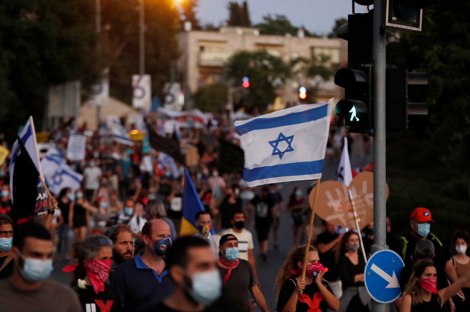 Israelis march as they protest against Israeli Prime Minister Benjamin Netanyahu and his government's response to the financial fallout of the coronavirus disease crisis in Jerusalem, July 21, 2020. (REUTERS)