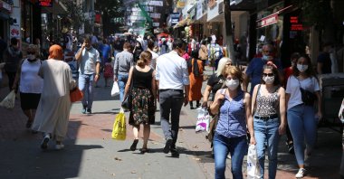 People wearing masks walk on a street in Kocaeli, in northwestern Turkey, July 22, 2020. (IHA Photo) 