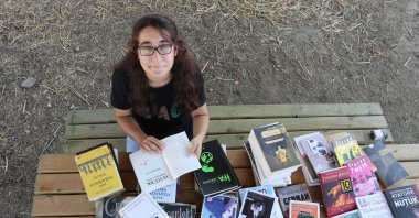 Suzan Keskin, a high school student in Aydın province's Koçarlı district, thumbs through a book given to her after media publicity about her passion for reading. (AA Photo)