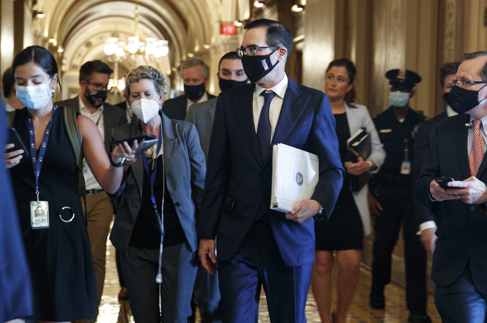 U.S. Treasury Secretary Steven Mnuchin (C) walks to a Republican luncheon while attending meetings on Capitol Hill, Washington, D.C., U.S., July 21, 2020. (AP Photo)