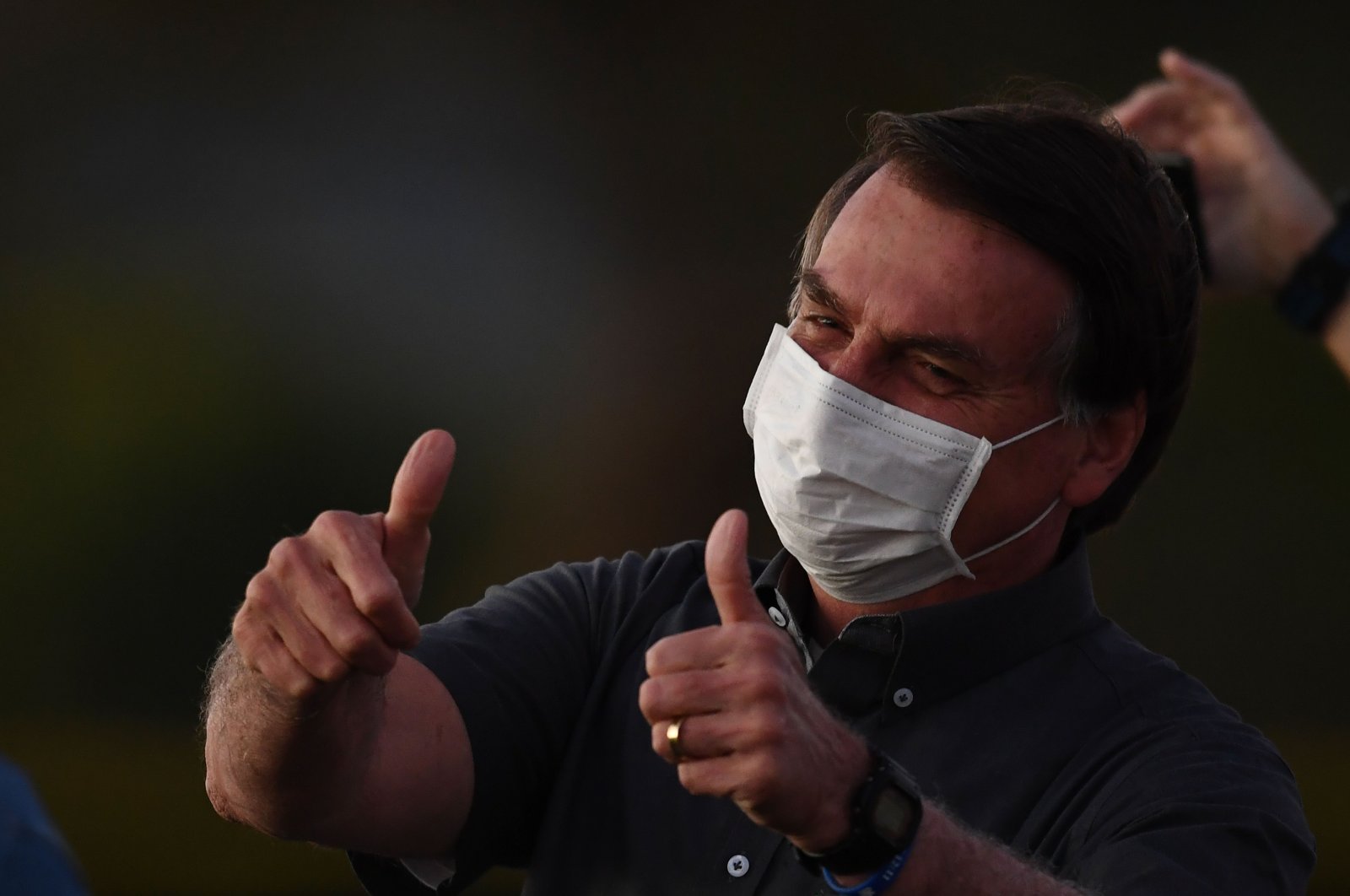 Brazilian President Jair Bolsonaro gives the thumbs up to supporters from the Alvorada Palace in Brasilia, July 20, 2020. (AFP Photo)
