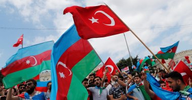 Azerbaijani men living in Turkey wave flags of Turkey and Azerbaijan during a protest following clashes between Azerbaijan and Armenia, in Istanbul, July 19, 2020. (Reuters Photo)