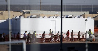 In this Dec. 13, 2018 file photo migrant teens walk in a line through the Tornillo detention camp in Tornillo, Texas. (AP File Photo)
