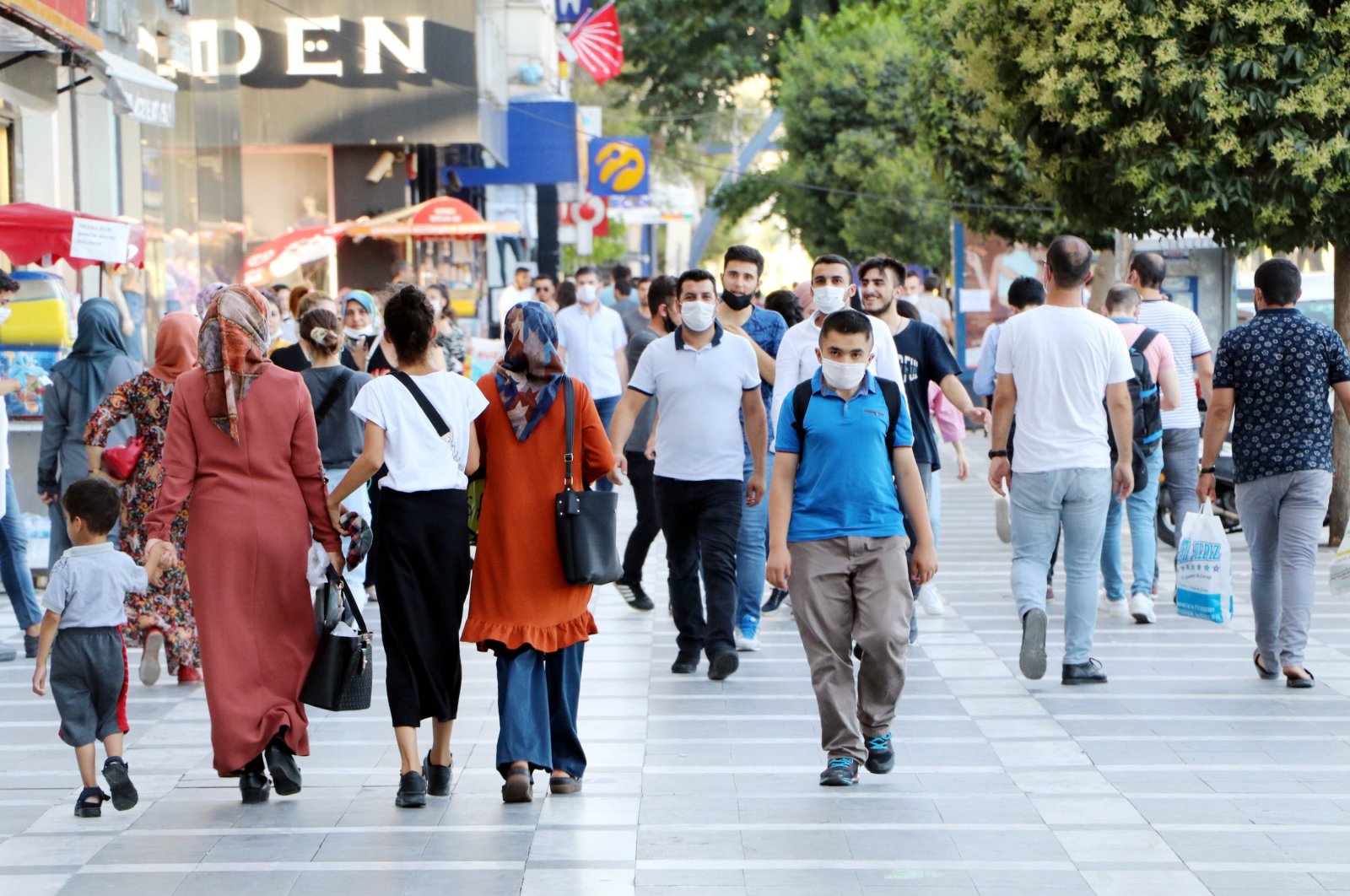 People wearing masks against COVID-19 walk on a street in Şanlıurfa, southeastern Turkey, July 24, 2020. (DHA Photo)