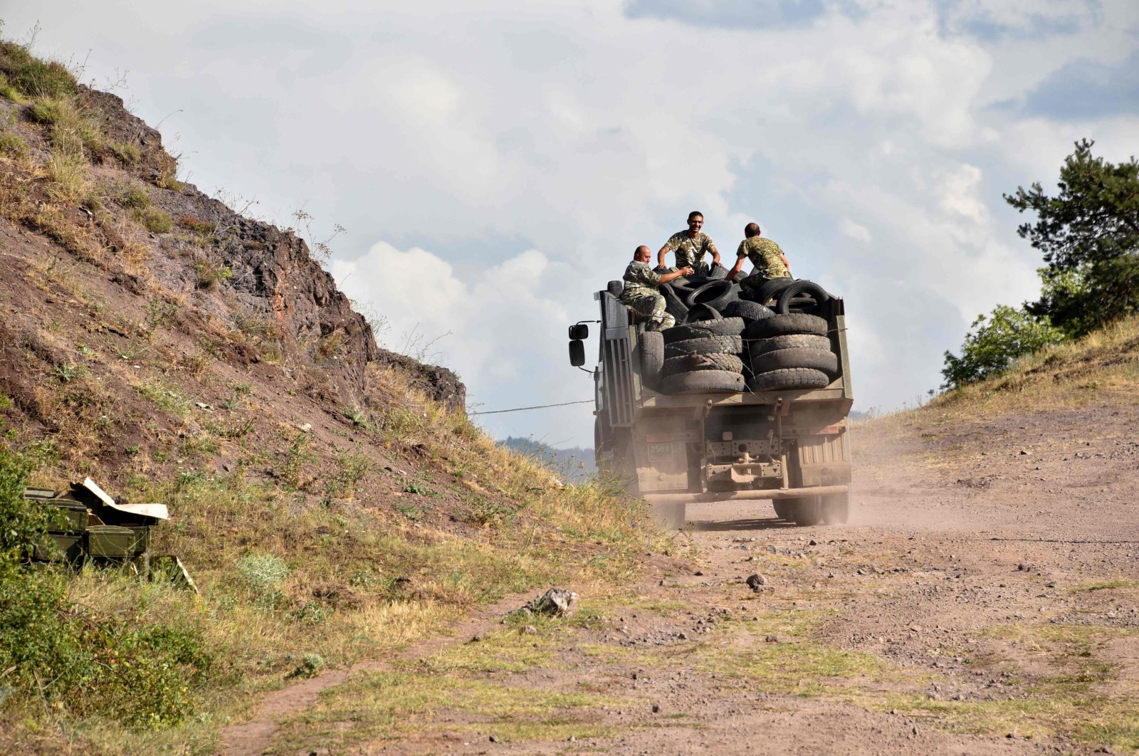 Armenian servicemen transport used tyres in the back of a truck to fortify their positions on the Armenian-Azerbaijani border near the village of Movses on July 15, 2020. (AFP Photo)