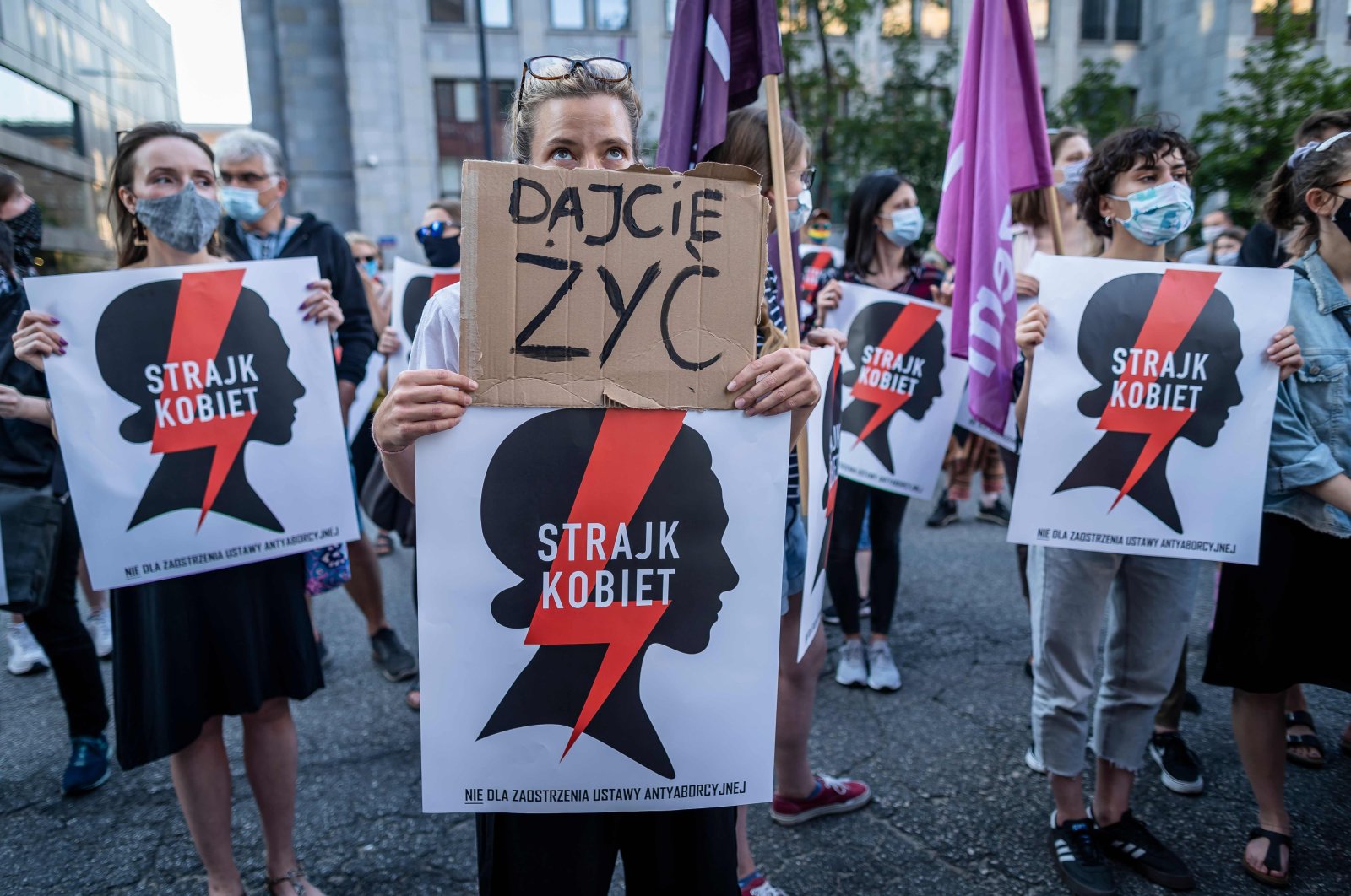 Protesters hold banners reading "Let us live" and "Women's Strike" as they take part in protest against the Polish government plans to withdraw from the Istanbul Convention on prevention and combatting of home violence, in Warsaw, Poland on July 24, 2020. (AFP Photo)