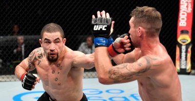 Robert Whittaker punches Darren Till in their middleweight championship fight during the UFC 251 event at UFC Fight Island on Abu Dhabi's Yas Island, UAE, July 26, 2020. (AFP Photo)