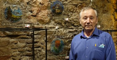 Kamil Akmanov poses with his Hagia Sophia works at the exhibition, Istanbul, Turkey, July 25, 2020. (AA PHOTO)