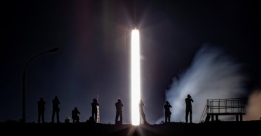 Photographers take pictures as the Soyuz MS-13 spacecraft carrying the crew formed of Andrew Morgan of NASA, Alexander Skvortsov of the Russian space agency Roscosmos and Luca Parmitano of European Space Agency blasts off to the International Space Station (ISS) from the launchpad at the Baikonur Cosmodrome, Kazakhstan, July 20, 2019. (Reuters Photo)