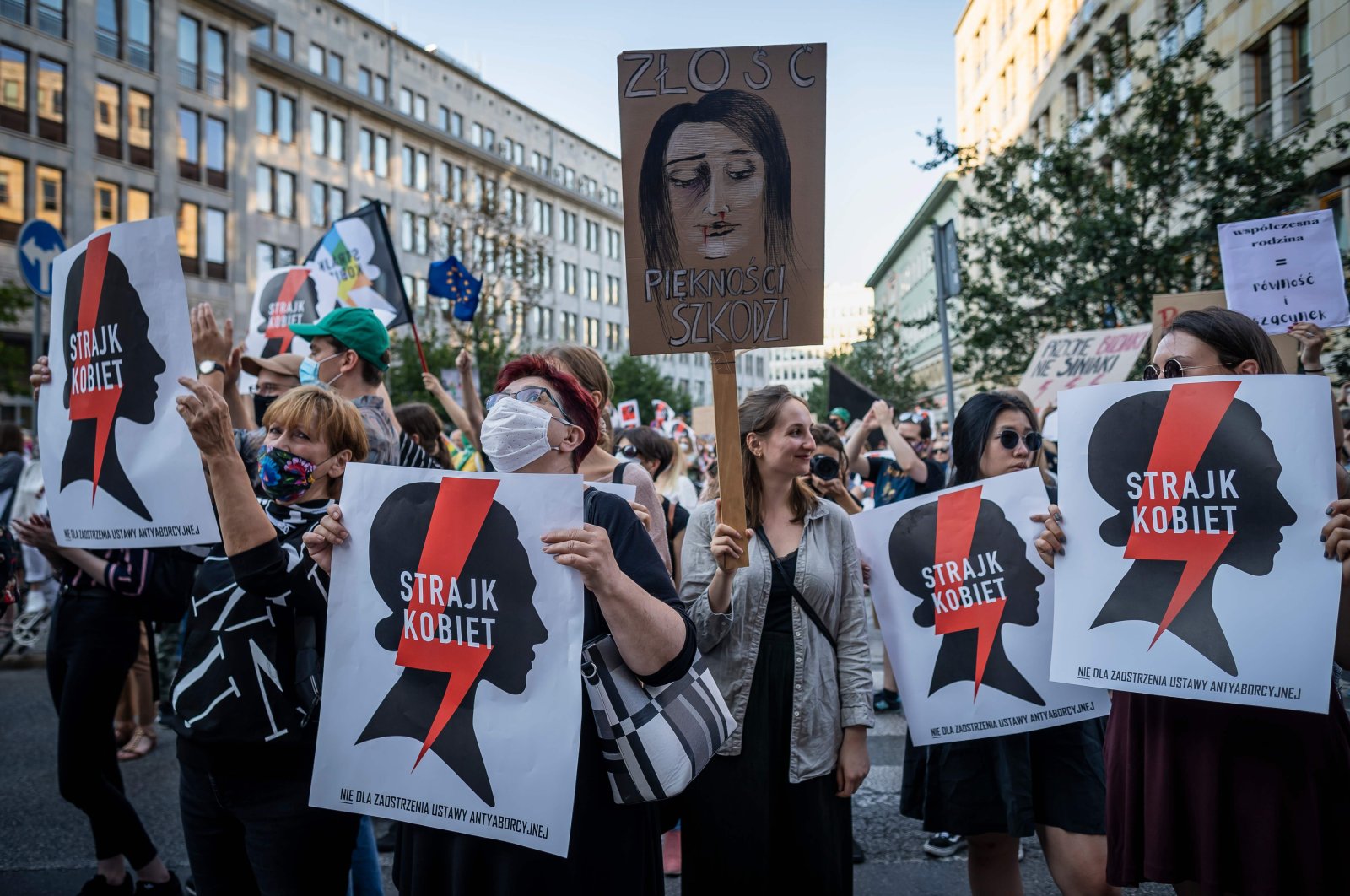 Protesters hold banners reading "Women's Strike" as they take part in a protest against the Polish government plans to withdraw from the Istanbul Convention on prevention and combatting of home violence, in Warsaw, Poland, July 24, 2020. (AFP Photo)