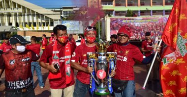 Thai fans of Liverpool Football Club celebrate the English Premier League win with a replica trophy cup as they gather for a parade in the southern Thai province of Narathiwat on July 27, 2020. (AFP Photo)