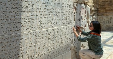 An archeologist studies stone carvings at the site of Ayanis Castle in Van, eastern Turkey, July 27, 2020. (AA Photo) 