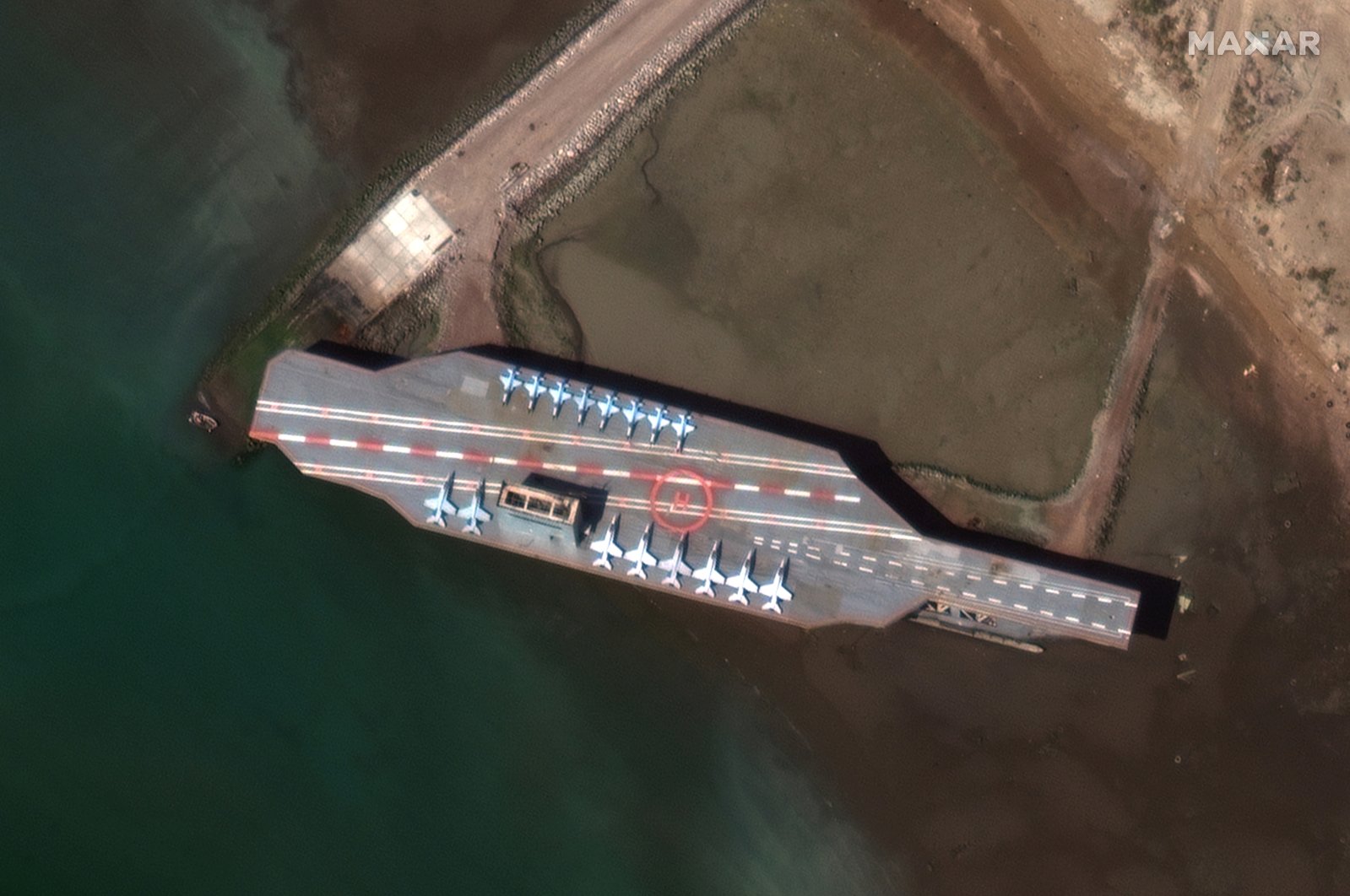 Iran's refurbished mock-up aircraft carrier, used previously as a simulated U.S. target during a February 2015 Iranian naval war games exercise, is seen at its homeport of Bandar Abbas, Iran, Feb.y 15, 2020. ( Satellite image ©2020 Maxar Technologies Photo via Reuters)