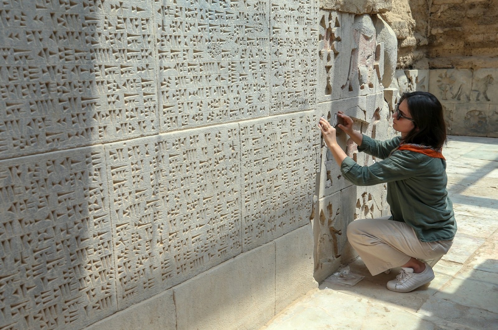 An archeologist studies stone carvings at the site of Ayanis Castle in Van, eastern Turkey, July 27, 2020. (AA Photo) 