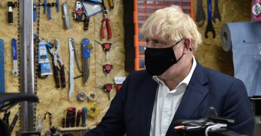 Britain's Prime Minister Boris Johnson talks to the owner of the the Cycle Lounge, Rodney Rouse, a bicycle repair shop, after the government announced a new plan to get Britain cycling, amid the outbreak of the coronavirus, in Beeston near Nottingham, Britain, July 28, 2020. (Reuters Photo)