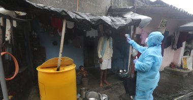 A health worker screens people for COVID-19 symptoms at a slum in Mumbai, India, July 14, 2020. (AP Photo)