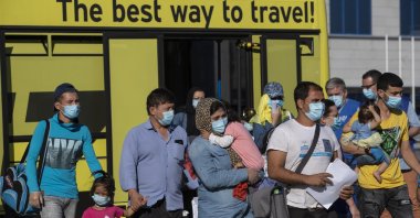 A group of migrant children with health issues board a plane to Germany, at Athens International Airport, Spata-Artemida, Greece, July 24, 2020. (AP Photo)