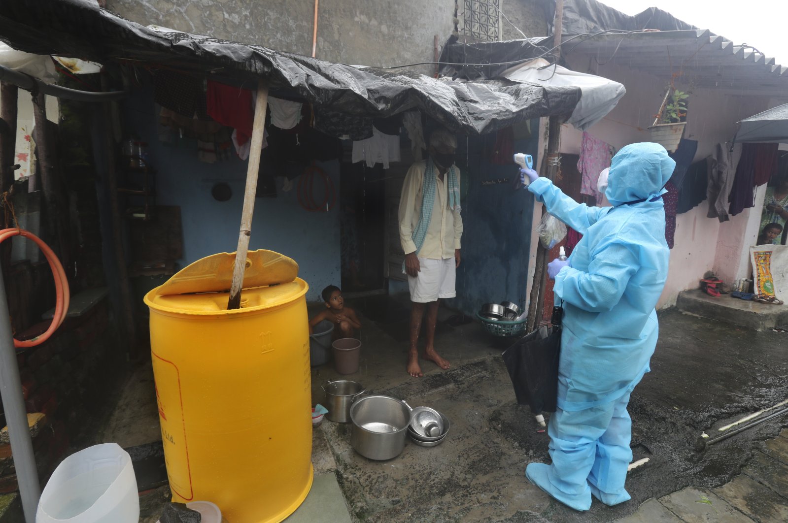 A health worker screens people for COVID-19 symptoms at a slum in Mumbai, India, July 14, 2020. (AP Photo)