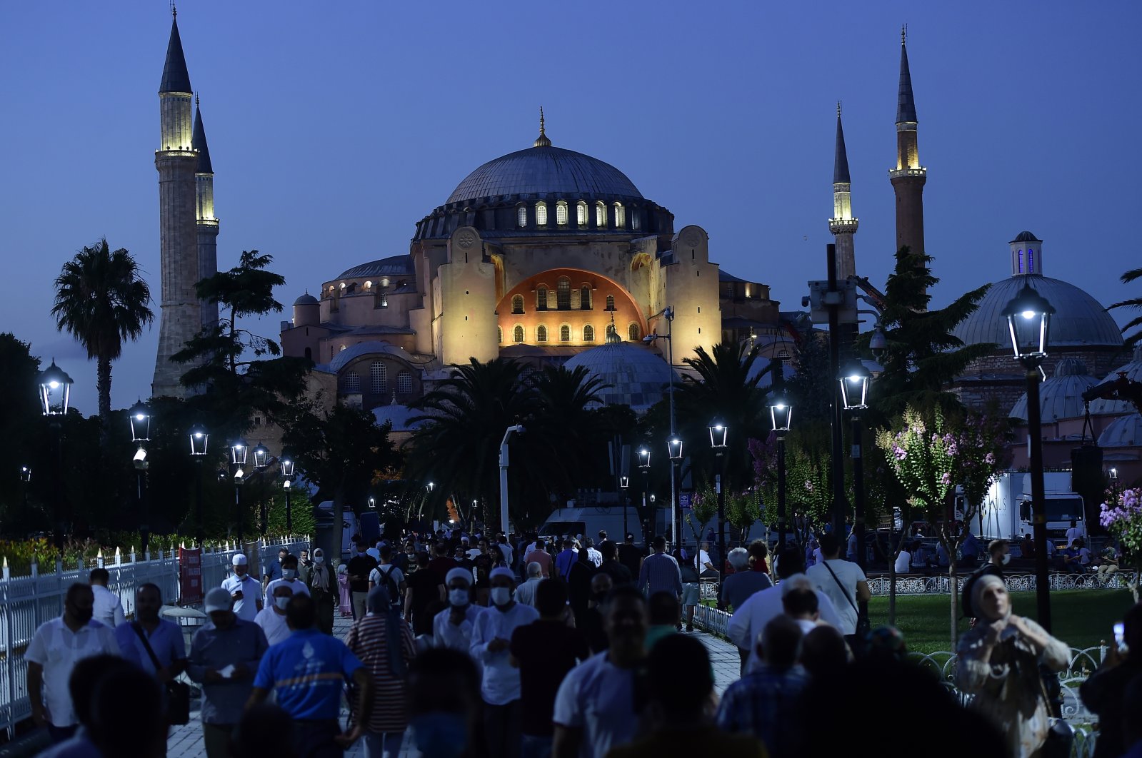 People walk backdropped by the Byzantine-era Hagia Sophia, in the historic Sultanahmet district of Istanbul, July 24, 2020. (AP Photo)