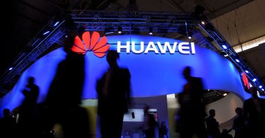 Visitors walk in front of the Huawei stand on the first day of the Mobile World Congress in Barcelona, Spain, Feb. 27, 2017. (AFP Photo)