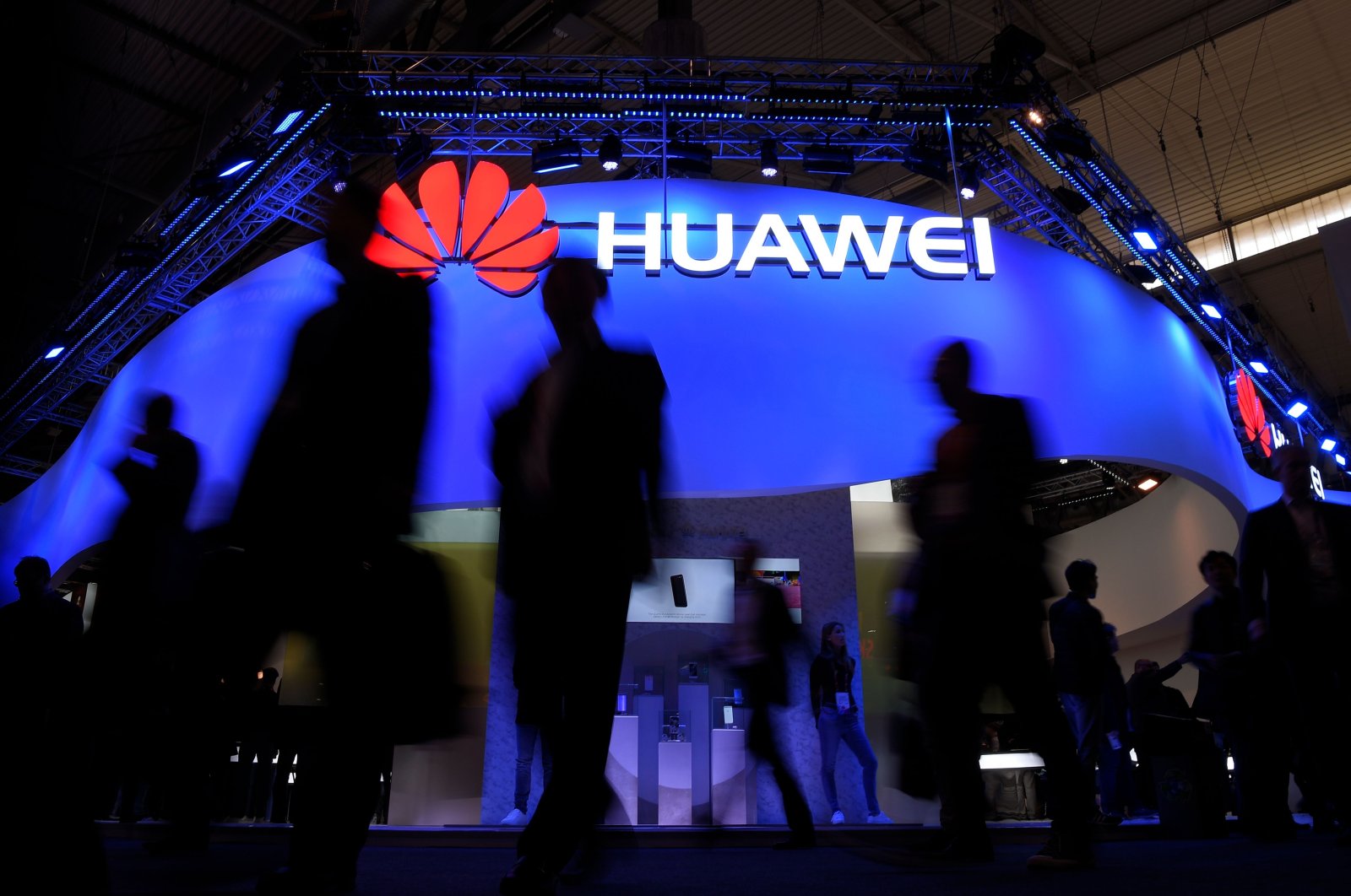 Visitors walk in front of the Huawei stand on the first day of the Mobile World Congress in Barcelona, Spain, Feb. 27, 2017. (AFP Photo)