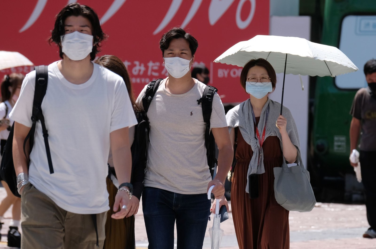 People wearing face masks walk across Shibuya Crossing in the Shibuya shopping and entertainment district in Tokyo, Japan, July 26, 2020. (AFP Photo)