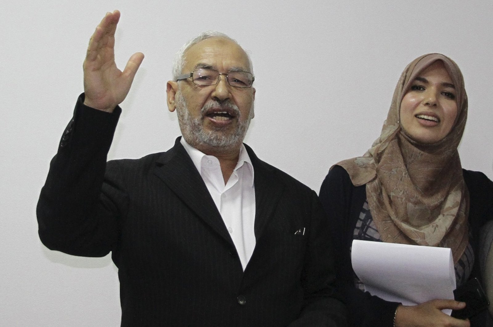 Rashid al-Ghannushi, Tunisian leader and founder of the moderate party Ennahda, celebrates an electoral victory with his daughter at the party's headquarters in Tunis, Tunisia, Oct. 27, 2011. (AP Photo)