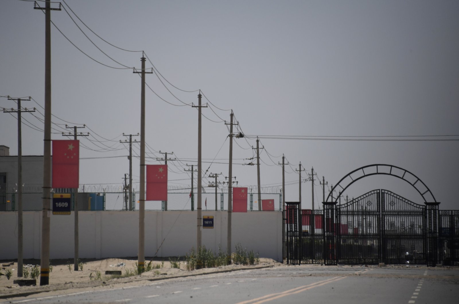 Chinese flags on a road leading to a facility believed to be a re-education camp where mostly Muslim ethnic minorities are detained, on the outskirts of Hotan, Xinjiang Uighur Autonomous Region, northwest China, May 31, 2019. (AFP File Photo)