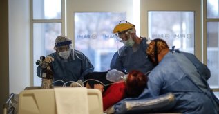 Medical personnel transport a COVID-19 patient at the Bicentennial Hospital of Esteban Echeverria in Buenos Aires, Argentina, on 30 July 2020 (EPA Photo)
