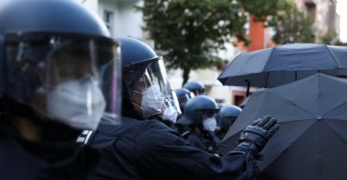 Police officers wear face masks during a demonstration against the eviction of the pub "Syndikat" and of the former group Liebig 34 in Berlin, Germany, Aug. 1, 2020. (Reuters Photo)
