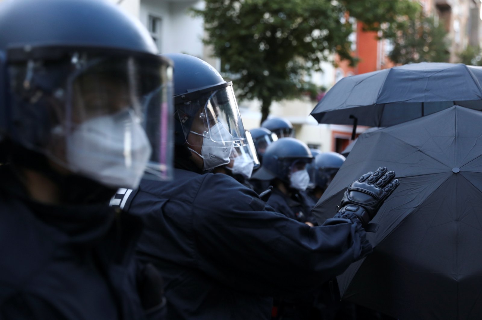 Police officers wear face masks during a demonstration against the eviction of the pub "Syndikat" and of the former group Liebig 34 in Berlin, Germany, Aug. 1, 2020. (Reuters Photo)
