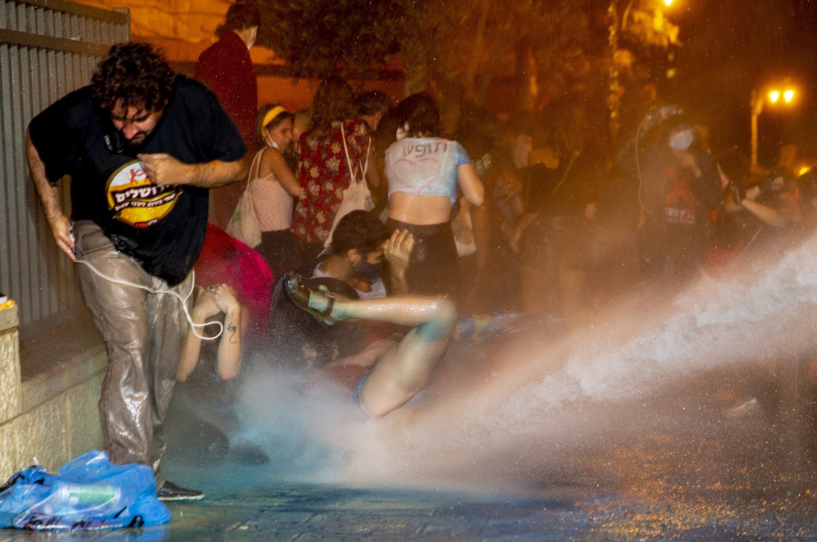 Police use a water cannon to disperse demonstrators during a protest against Israel's Prime Minister Benjamin Netanyahu outside his residence in Jerusalem, July 22, 2020. (AP Photo)