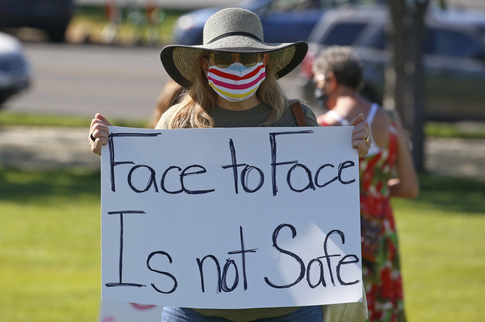 A teacher attends a Utah Safe Schools Mask-In urging the governor's leadership in school reopening during a rally in Salt Lake City, Utah, U.S., July 23, 2020. (AP Photo)