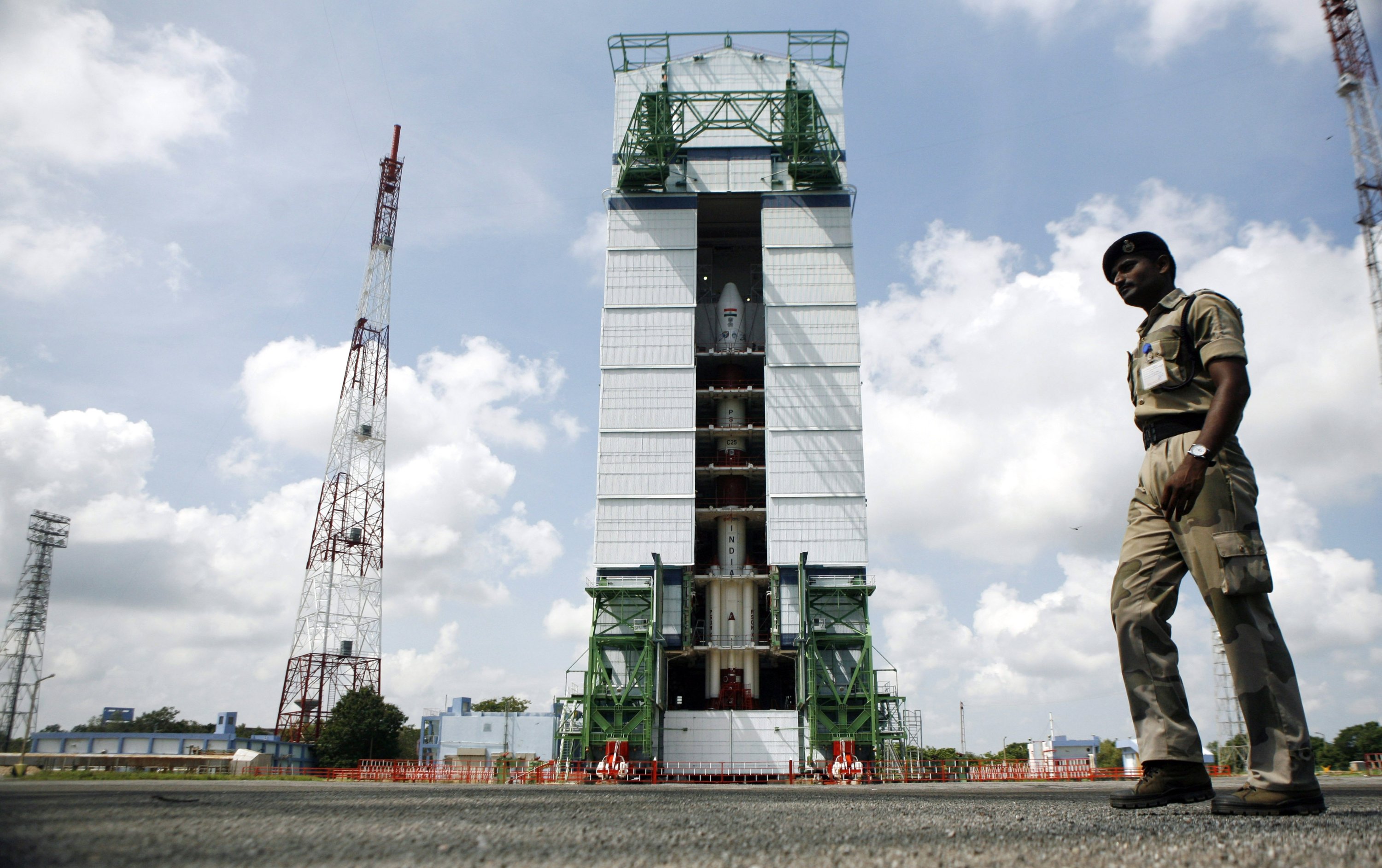 A paramilitary soldier walks past the Polar Satellite Launch Vehicle (PSLV-C25) at the Satish Dhawan Space Center at Sriharikota, in the southern Indian state of Andhra Pradesh, Wednesday, Oct. 30, 2013. (AP Photo)